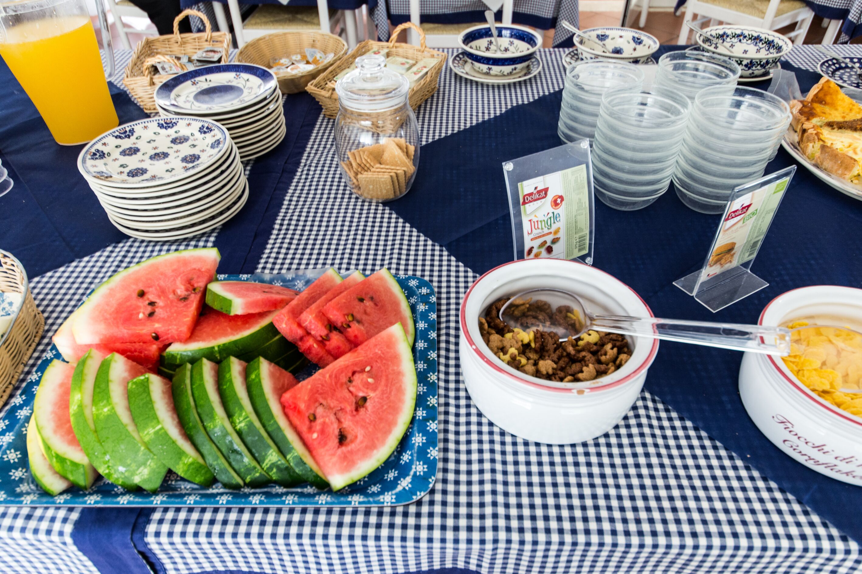 A breakfast buffet with various food items and utensils.