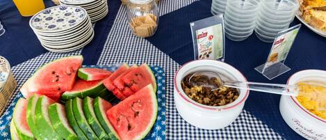 A breakfast buffet with various food items and utensils.