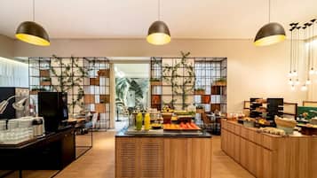 A modern kitchen with wooden cabinets, a central island, and pendant lighting.
