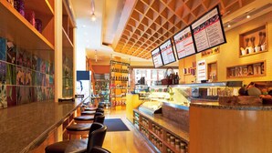 A restaurant interior with a bar area, seating, and a menu display. - The Westin Bund Center, Shanghai (Shanghai)