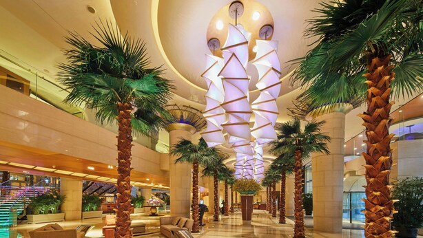 A spacious lobby with palm trees, a central staircase, and a modern ceiling design. - The Westin Bund Center, Shanghai (Shanghai)