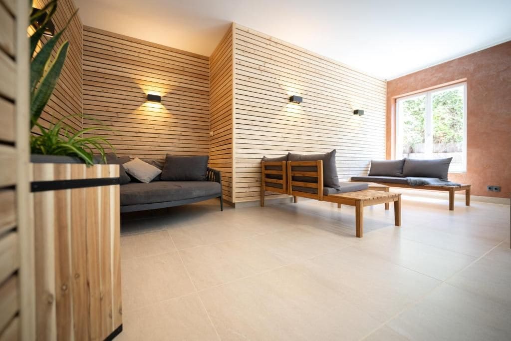 A modern living room with a sofa, a wooden coffee table, and a bench.