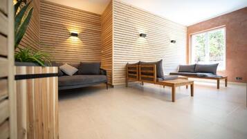 A modern living room with a sofa, a wooden coffee table, and a bench.