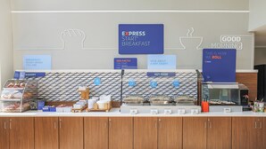 A breakfast buffet area with signs indicating 'EXPRESS START BREAKFAST', 'EGG-XACTLY THE START YOU NEED', and 'HOT FOOD'. - Holiday Inn Express & Suites Raleigh North - Wake Forest by IHG (Raleigh)