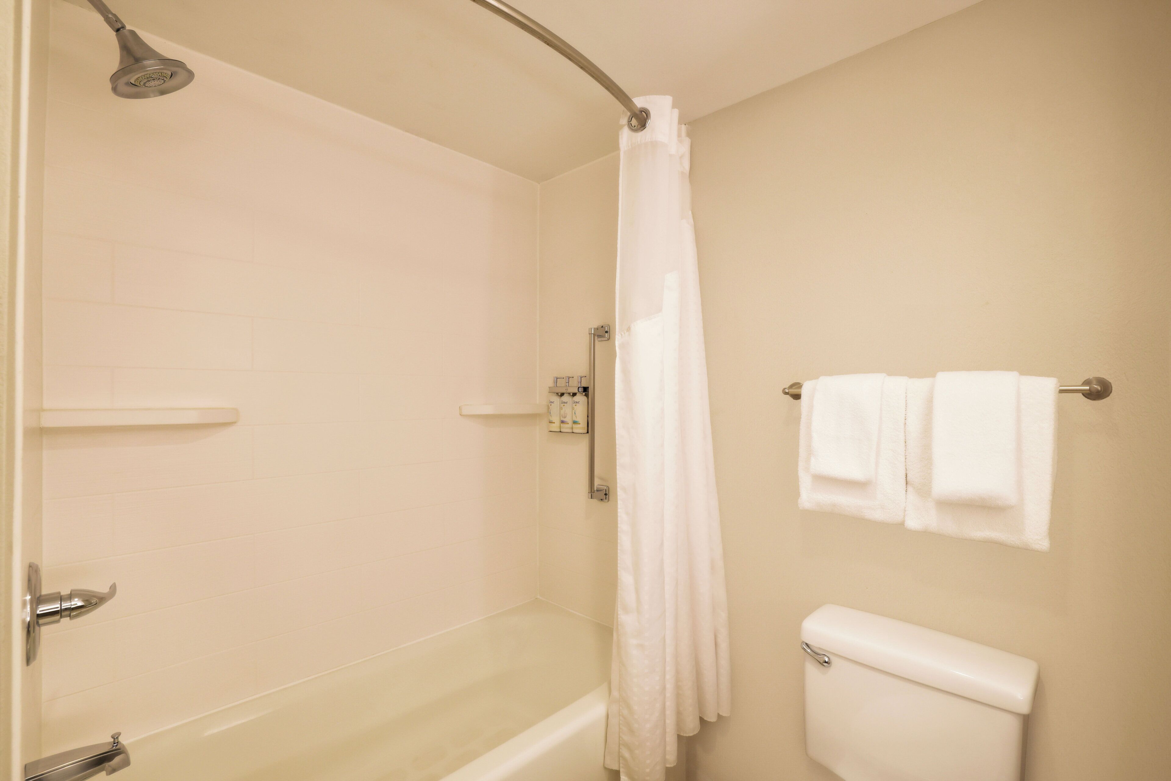 A bathroom with a bathtub, a shower, and a toilet.
