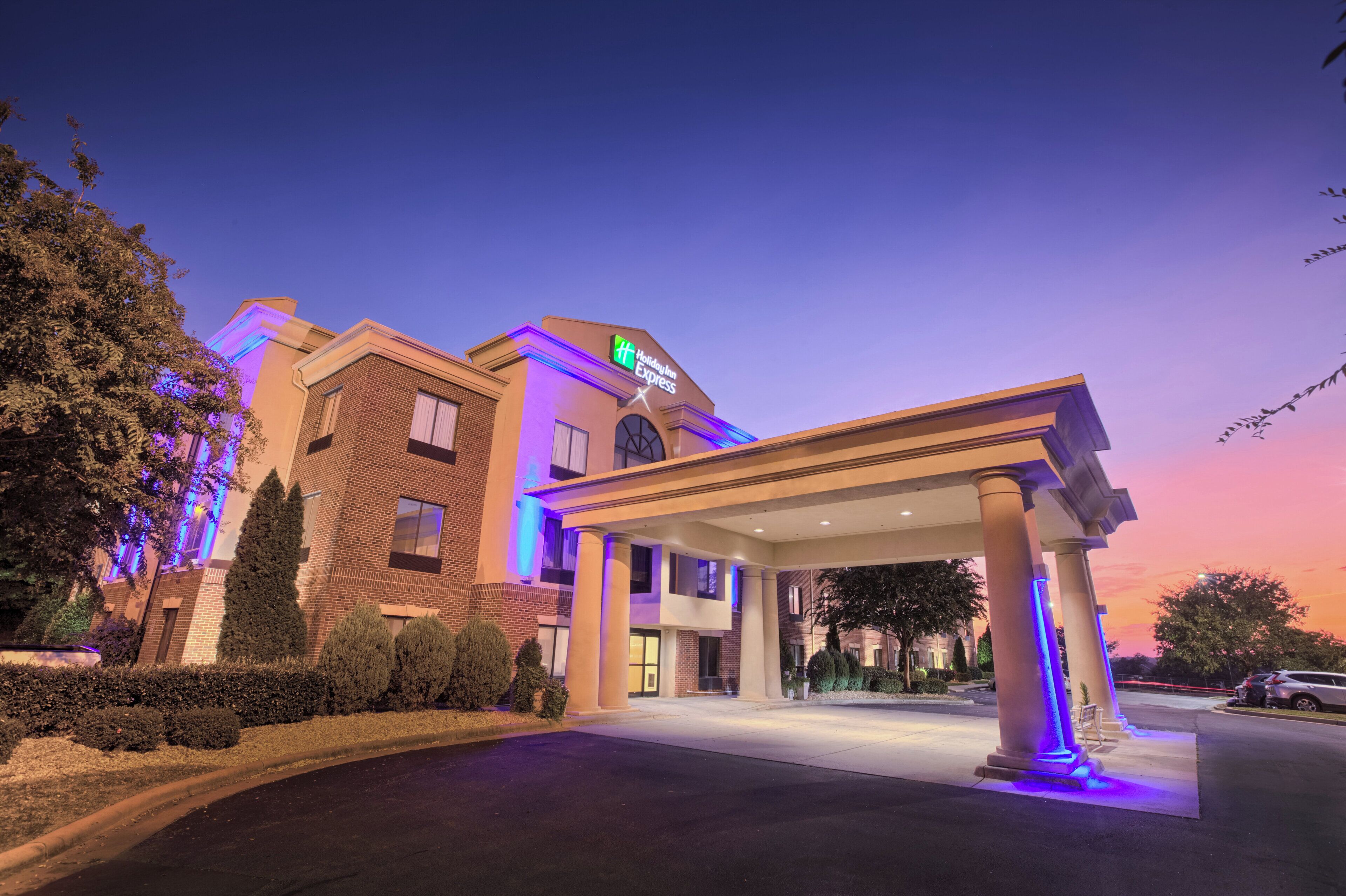 A Holiday Inn Express hotel with a covered entrance and a brick facade.