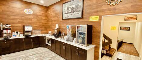 Un espace réservé au petit-déjeuner, avec un mur en bois, une horloge et une machine à café.