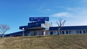 A Best Stay Inn building with a prominent sign, a flat roof, and a small lawn in front. - Best Stay Inn - Manchester (Manchester)