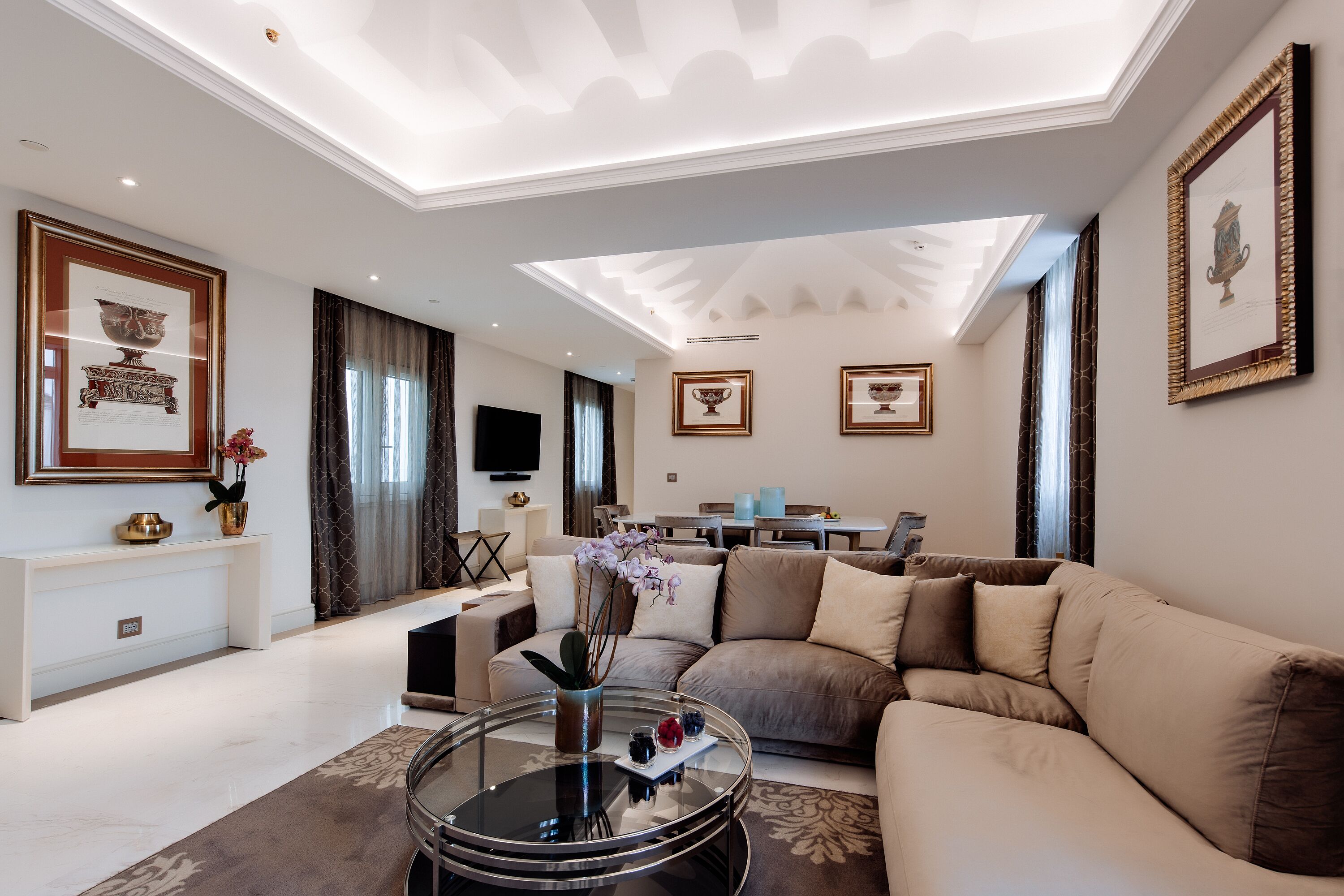 A modern living room with a sofa, coffee table, and a flat-screen TV.