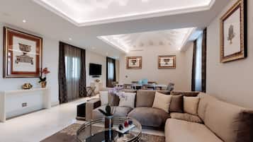A modern living room with a sofa, coffee table, and a flat-screen TV.
