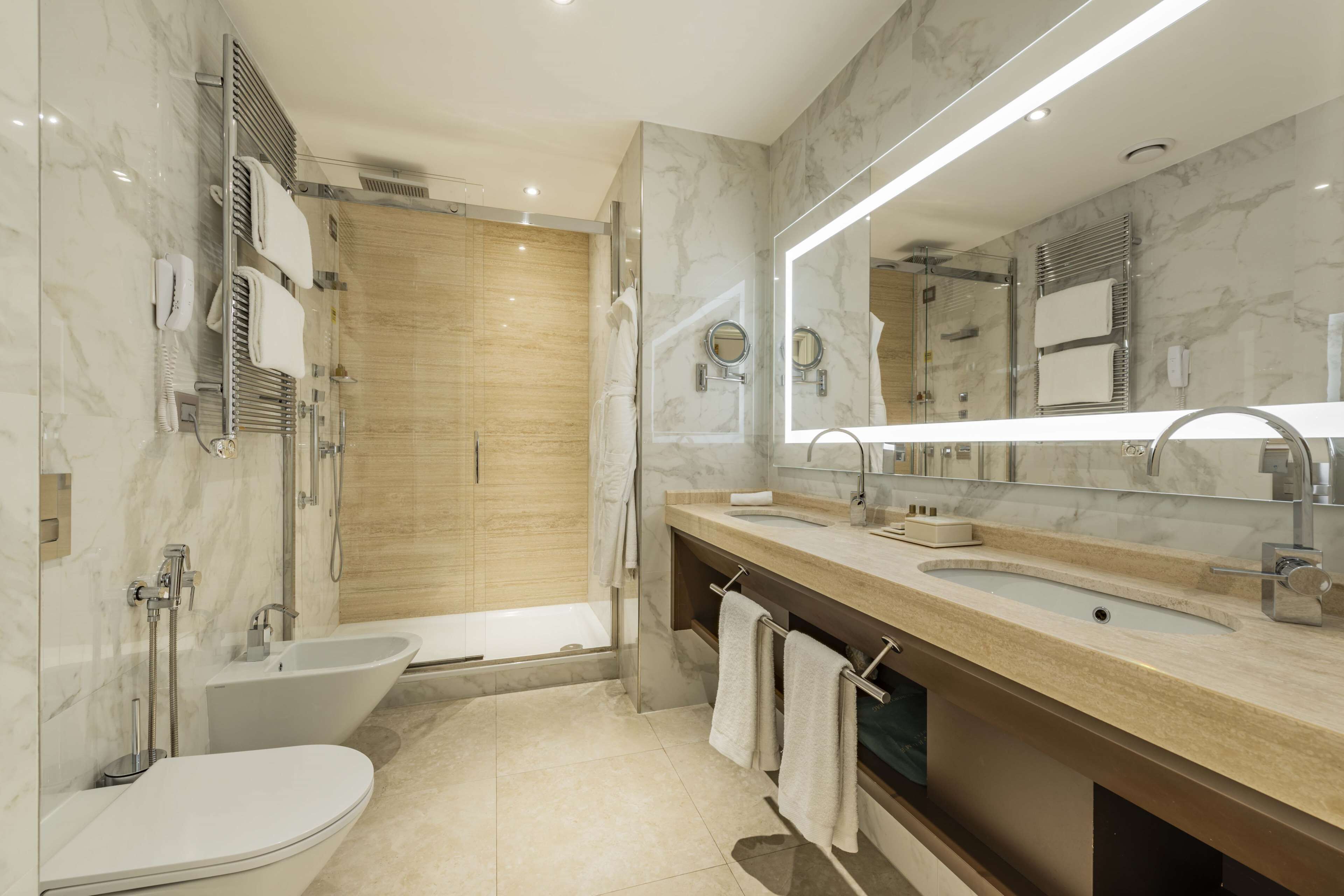 A modern bathroom with a bathtub, a sink, and a toilet.