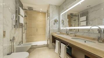 A modern bathroom with a bathtub, a sink, and a toilet.