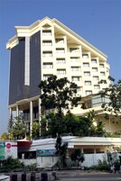A multi-story hotel with a modern design, featuring a prominent glass facade and a flat roof.