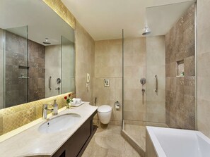 A modern bathroom with a large mirror, a bathtub, a shower, and a toilet. - La Place Sarovar Portico, Lucknow (Lucknow)