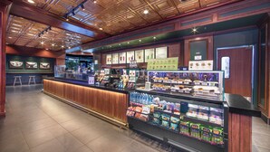 A well-lit food court with a variety of food options, seating areas, and a counter with beverages. - El Cortez Hotel and Casino - 21 and Over (Las Vegas)