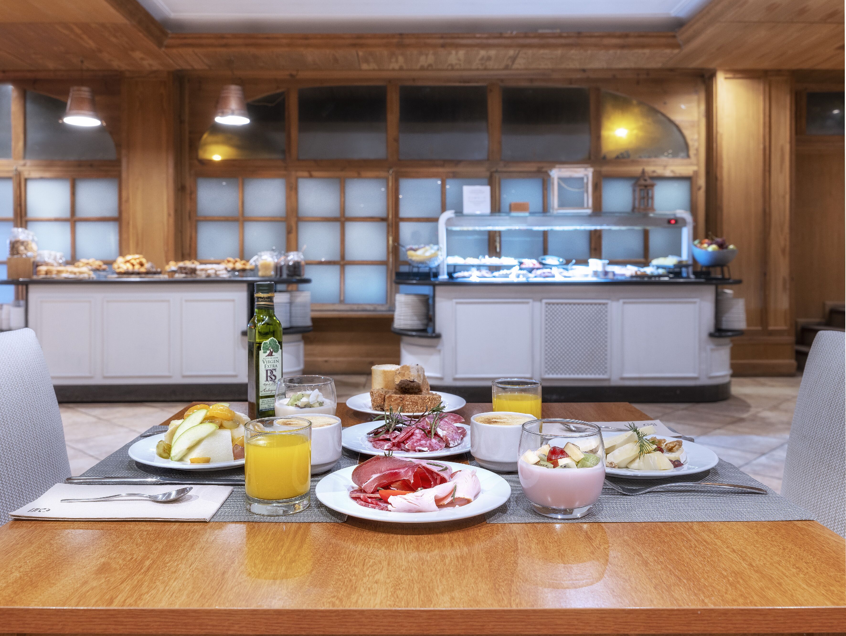 A breakfast buffet with various food items and drinks.