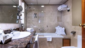 A modern bathroom with a bathtub, toilet, and sink.