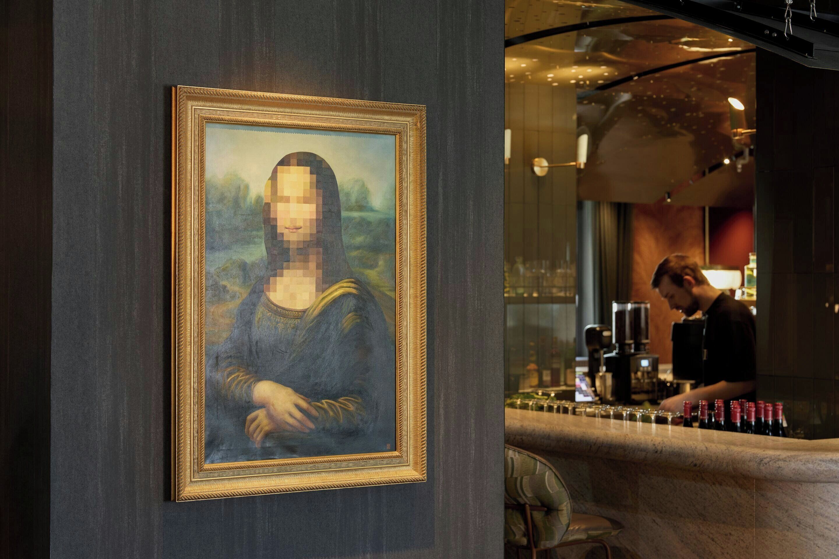 A bar area with a pixelated artwork of a famous painting on the wall.