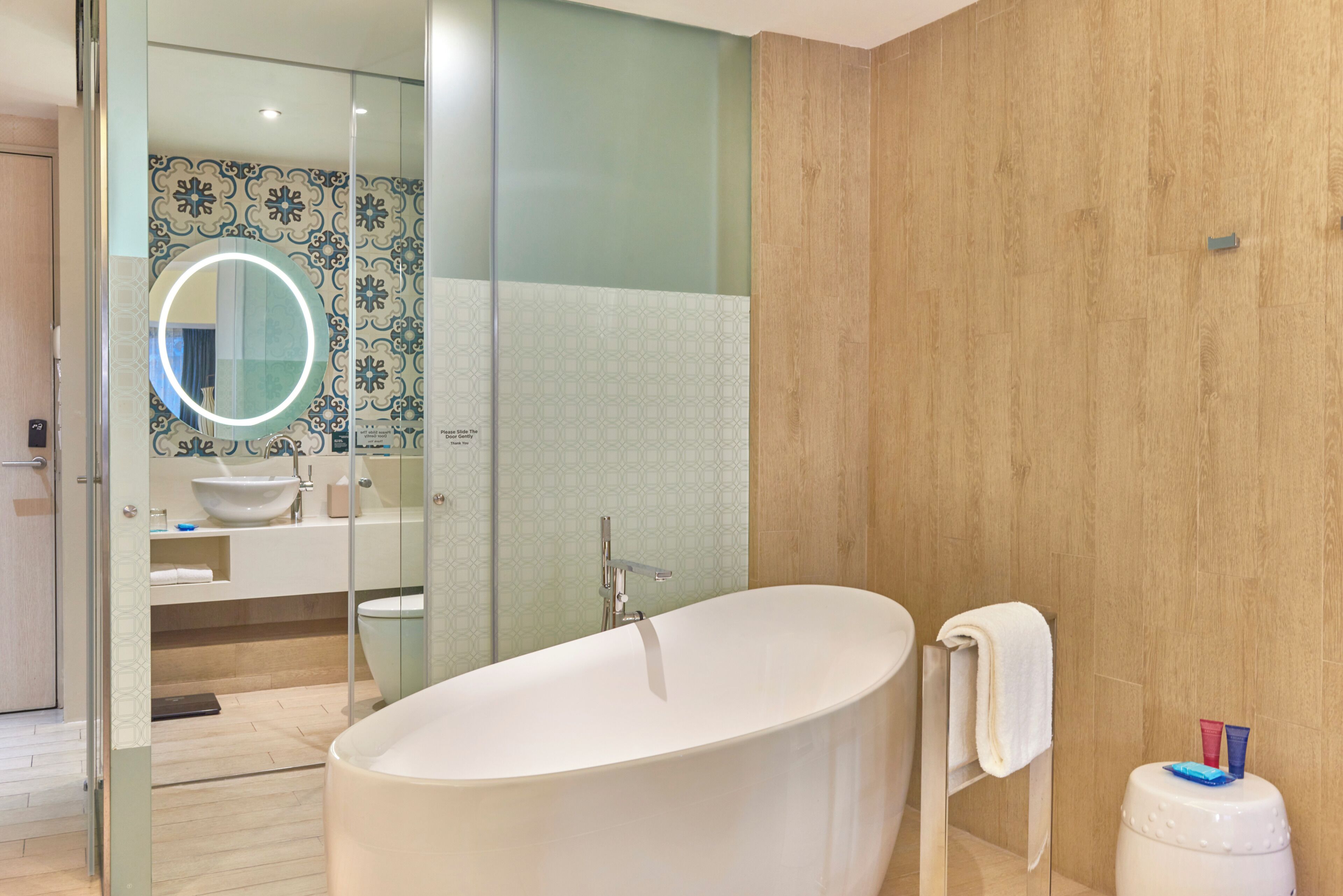 A modern bathroom with a freestanding bathtub, a glass-enclosed shower area, and a visible toilet.