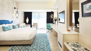 A hotel room with a large bed, a desk with a mirror, a chair, and a view of the outdoors. - Village Hotel Katong by Far East Hospitality (Singapore)