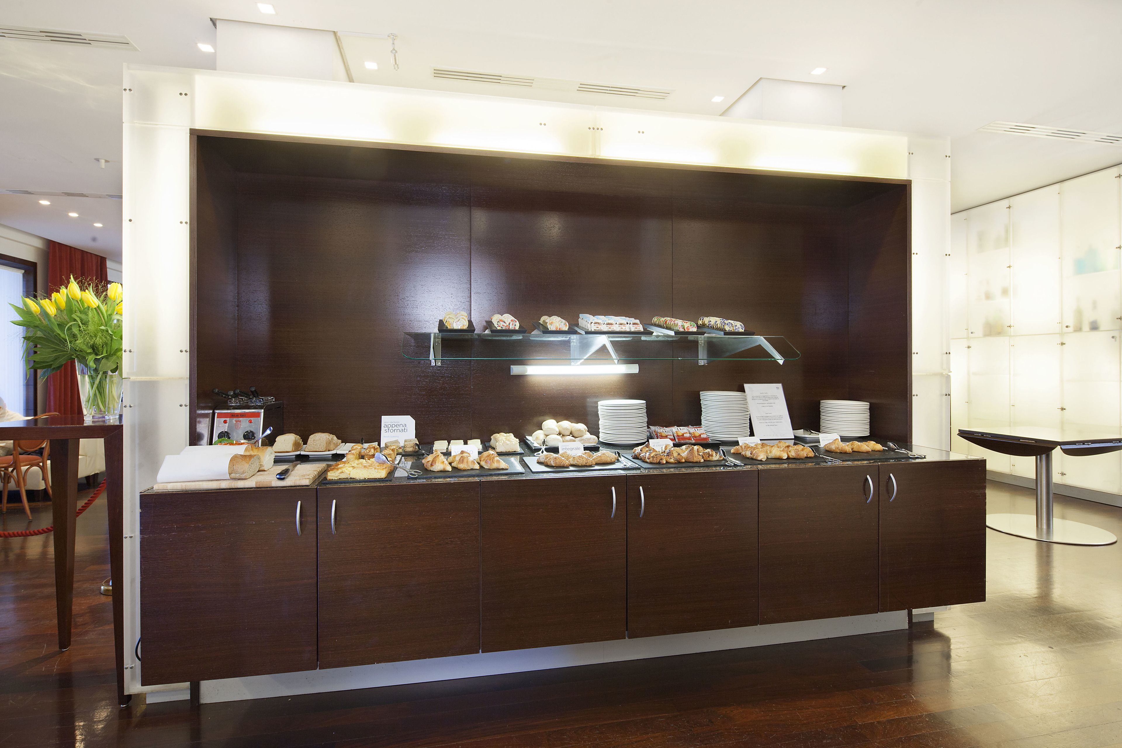 A buffet setup with various food items and a glass display case.