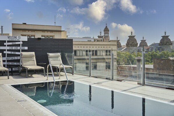 Piscine extérieure en saison, chaises longues