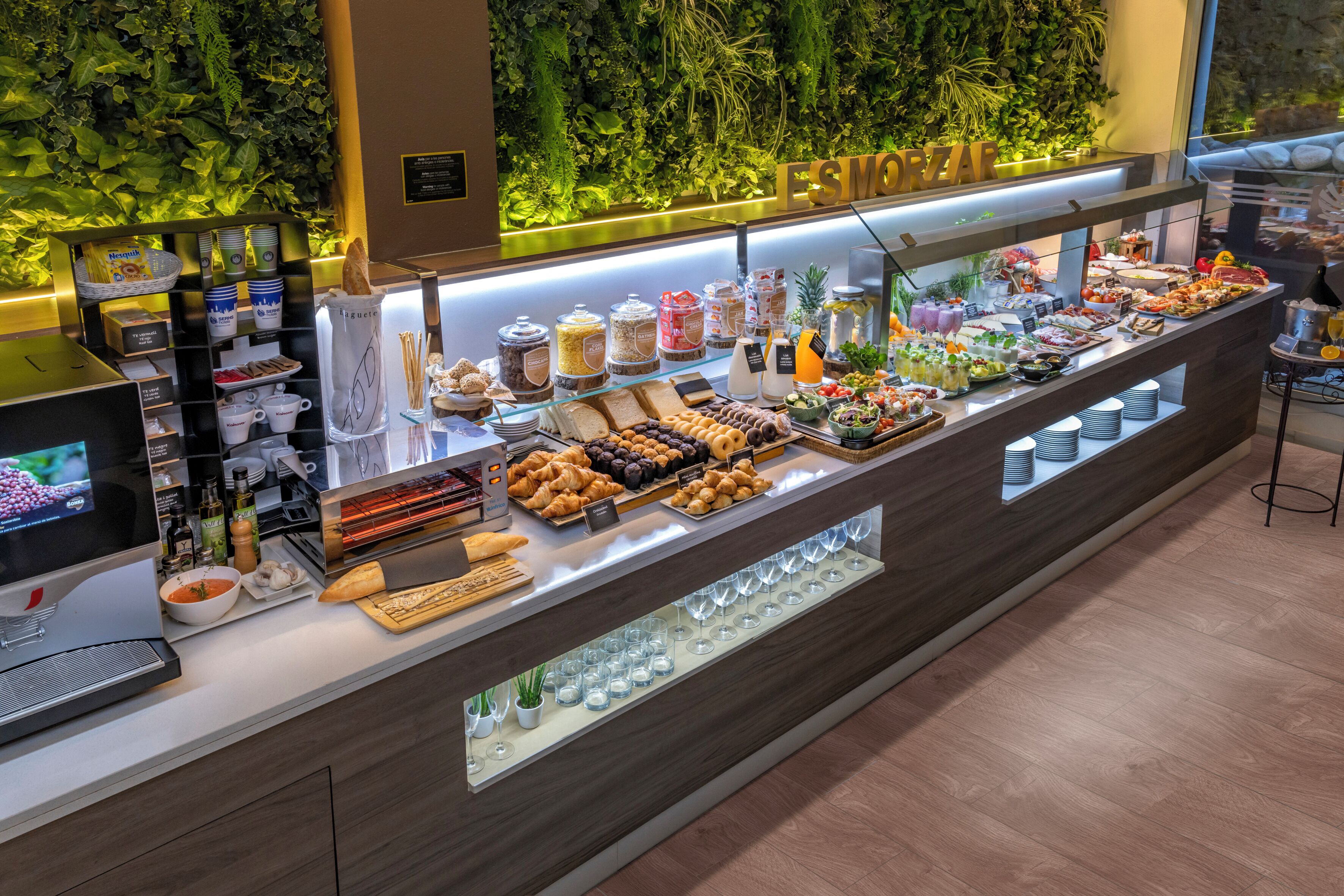 A buffet with various food items and a coffee station.