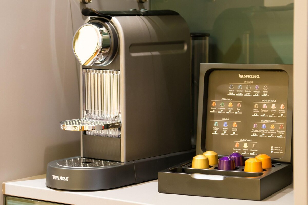 A Nespresso coffee machine with a variety of coffee options and a coffee pod holder.