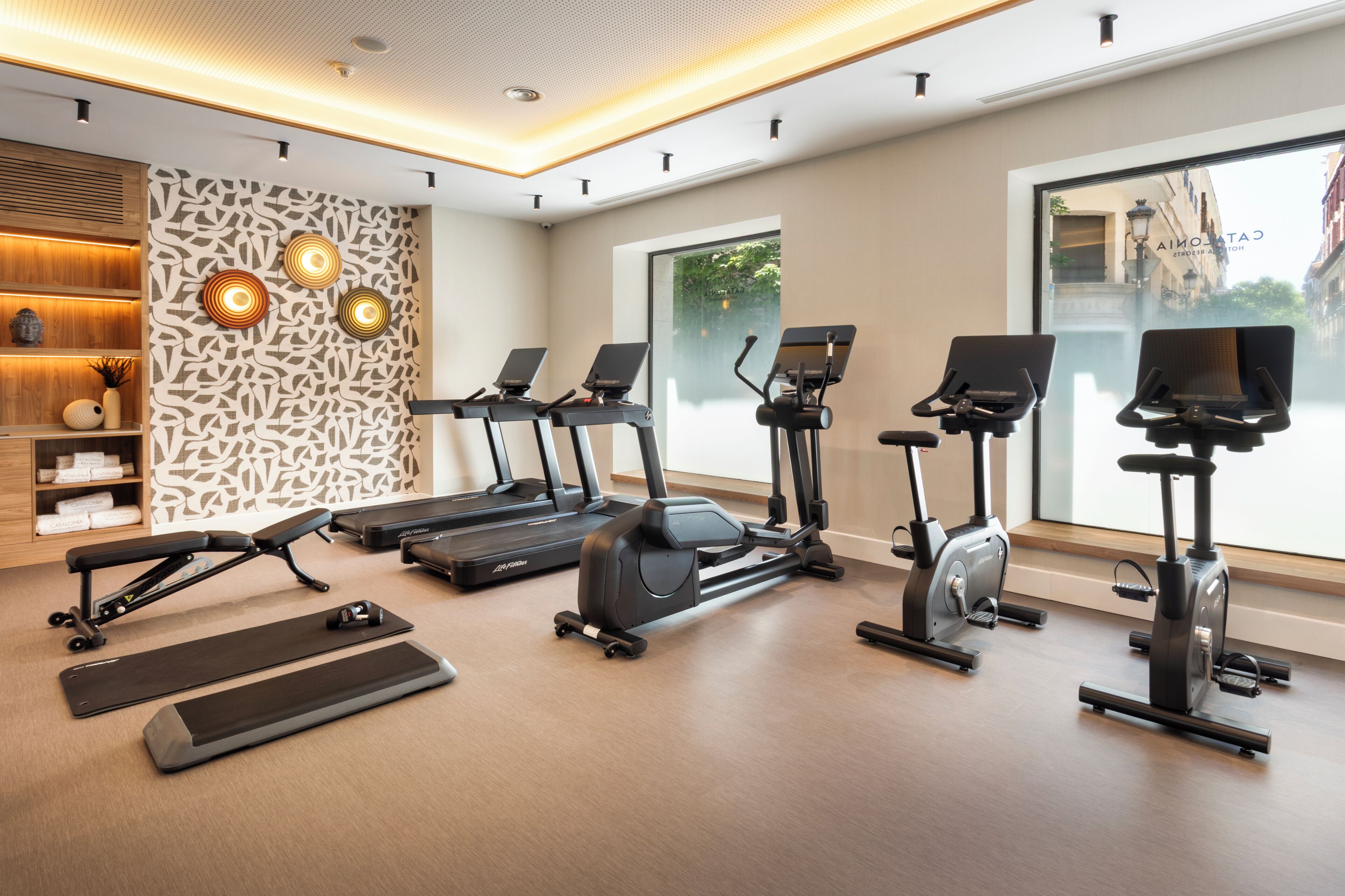 A gym with treadmills, stationary bikes, and a rowing machine.