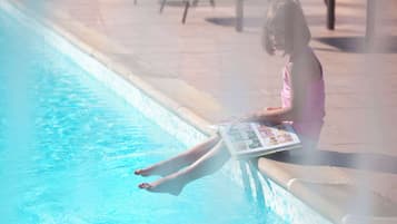 Guests can enjoy a refreshing swim in the pool surrounded by comfortable lounge chairs.