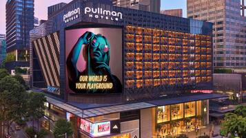 Experience the vibrant spirit of travel at Pullman Hotels, where a striking billboard sets the tone for a global adventure.