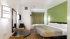 A hotel room with a bed, a desk, a chair, and a television. - Motel 6 Hillsboro, TX (Hillsboro)