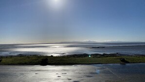A coastal landscape with a clear sky and the sun shining. - Powfoot Hotel (Annan)