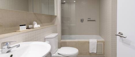 A modern bathroom with a sink, toilet, and shower area.