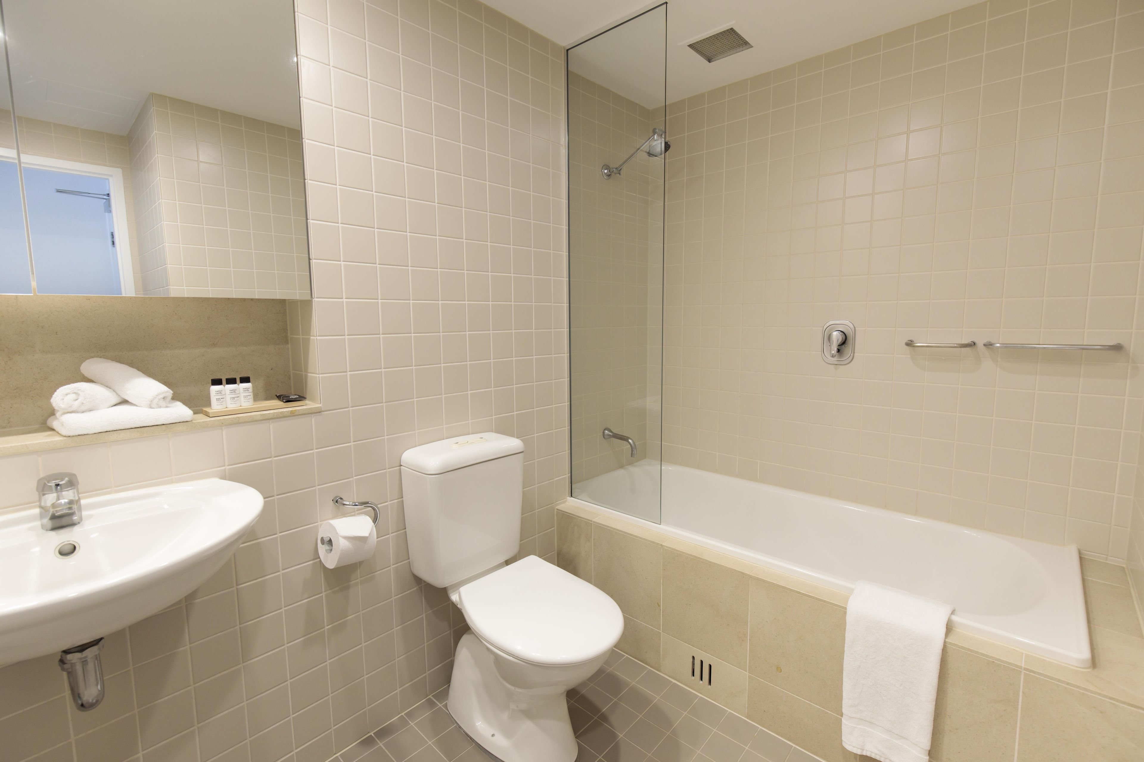 A bathroom with a sink, toilet, and bathtub.