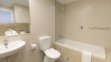 A bathroom with a sink, toilet, and bathtub.