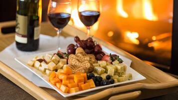 A cheese platter with crackers and grapes on a tray.