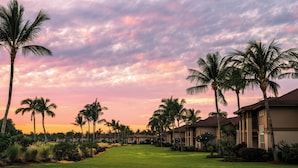 A resort with multiple buildings, palm trees, and a well-maintained lawn. - Waikoloa Colony Villas (Waikoloa)