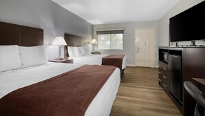 A hotel room with two beds, a TV, a desk, and a window. - Best Western Lake Conroe Inn (Montgomery)