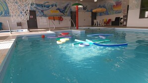 An indoor swimming pool with colorful lane dividers, a lifeguard stand, and a mural on the wall. - Super 8 by Wyndham Winnipeg East MB (Winnipeg)