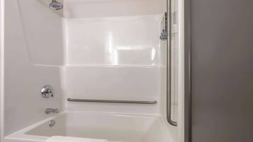 A modern bathroom with a bathtub, a shower, and a glass-enclosed shower area.