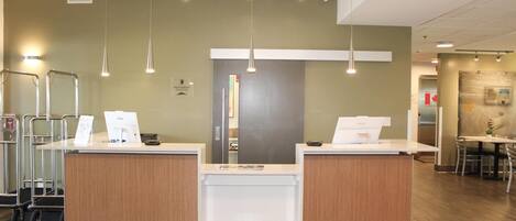 A reception area with two counters, a waiting area, and a dining area with a table and chairs.