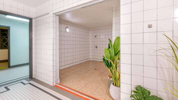 Bathroom features a shower area with a glass door and a showerhead.