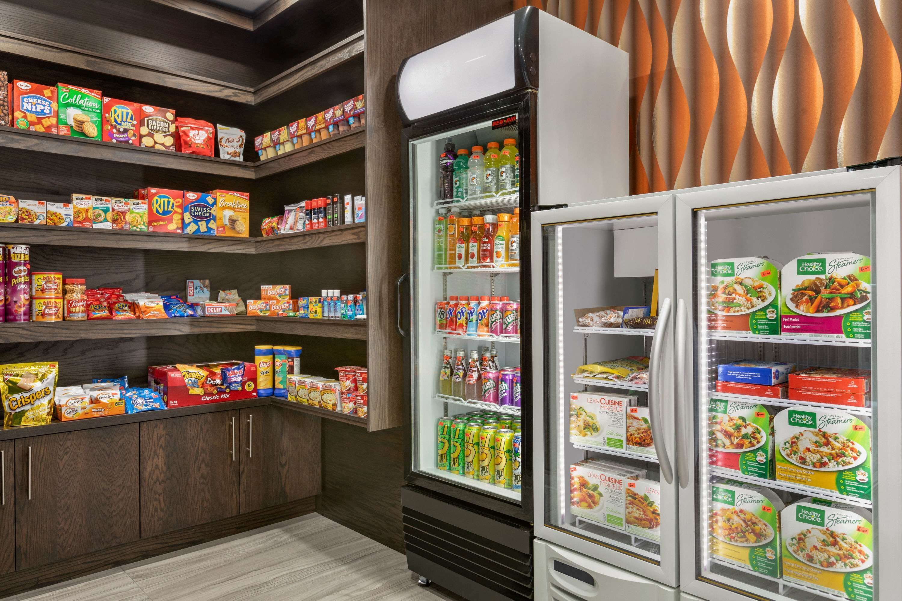 A grocery store with shelves stocked with snacks, drinks, and packaged foods.