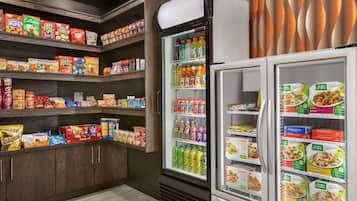 A grocery store with shelves stocked with snacks, drinks, and packaged foods.