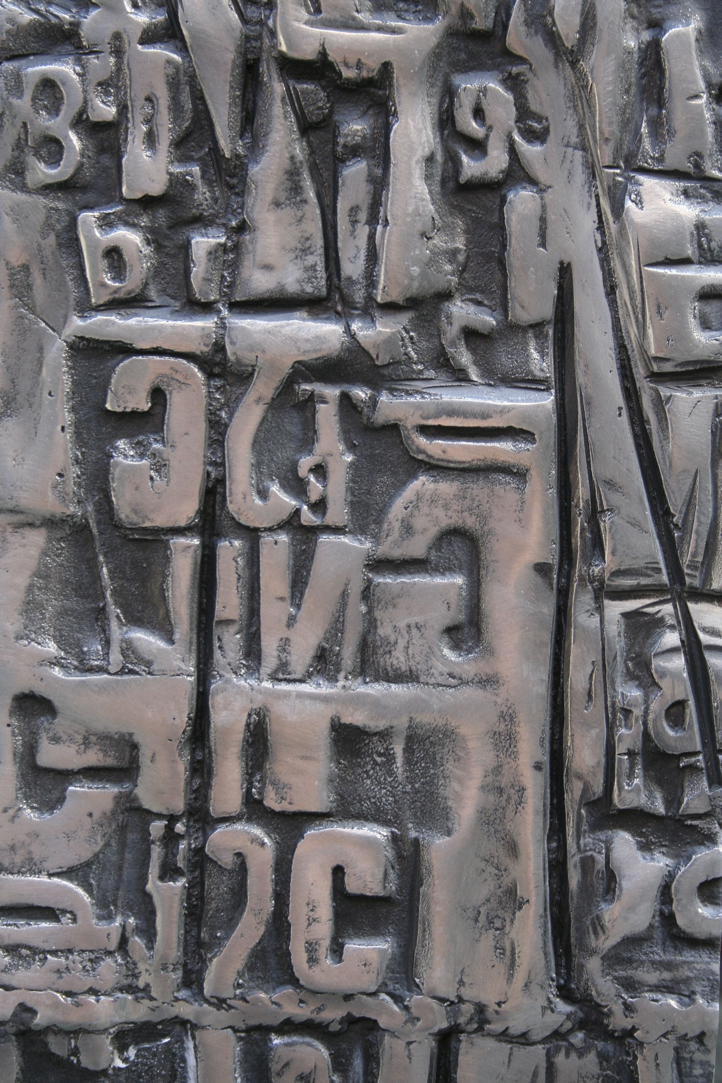 A close-up of a metallic surface with embossed text and numbers.