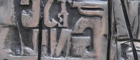 A close-up of a metallic surface with embossed text and numbers.