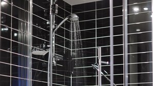 A modern bathroom with a glass-enclosed shower, chrome fixtures, and a tiled wall. - Holiday Inn Express Strathclyde Park M74 JCT 5 by IHG (Glasgow)