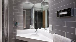 A modern bathroom with a large white sink, a glass shower enclosure, and a mirror. - Holiday Inn Express Strathclyde Park M74 JCT 5 by IHG (Glasgow)