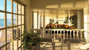 A balcony with a railing, a potted plant, and a view of the sea. - Canvas by Mitsis Belvedere (Corfu)